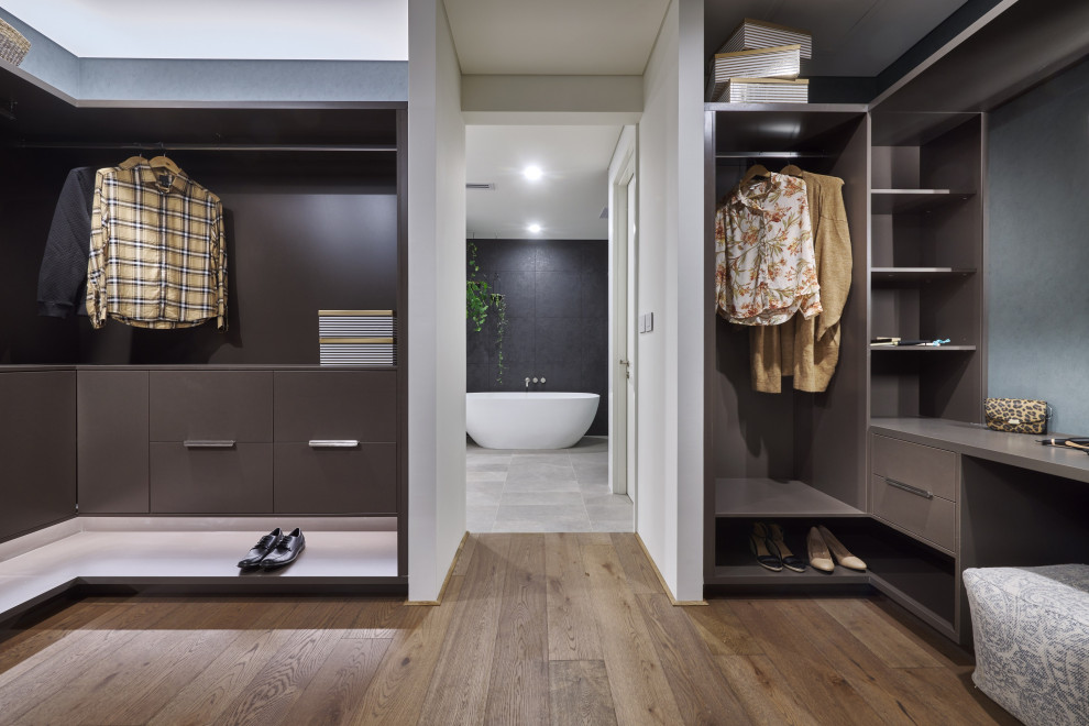 Photo of a modern gender-neutral storage and wardrobe in Perth with open cabinets and brown cabinets.