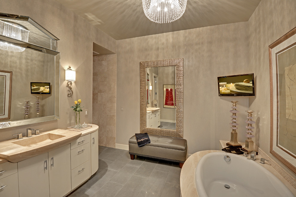 Inspiration for a transitional beige tile drop-in bathtub remodel in Minneapolis with an integrated sink, flat-panel cabinets and beige cabinets
