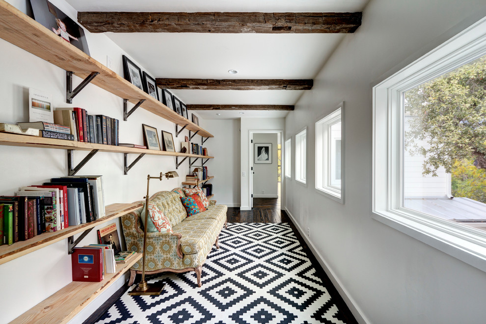 Large trendy dark wood floor hallway photo in Austin with white walls