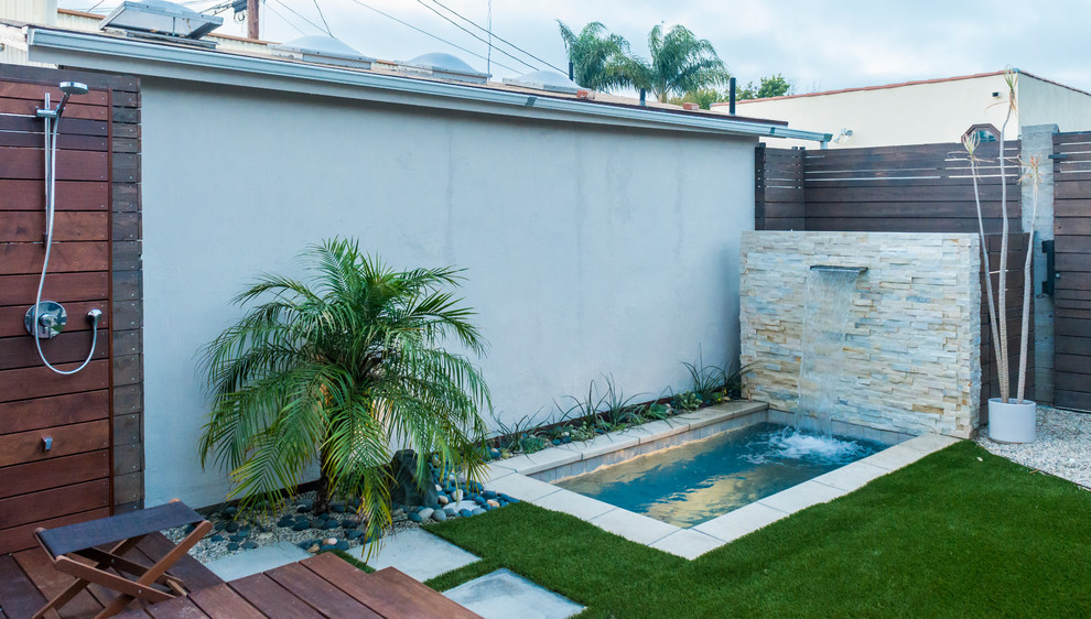 Inspiration for a mid-sized contemporary backyard concrete paver patio remodel in Los Angeles with a fire pit and a gazebo