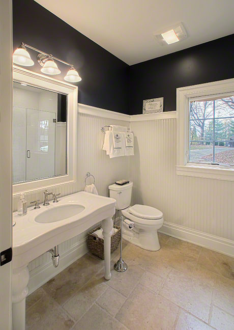 Design ideas for a mid-sized transitional 3/4 bathroom in Chicago with an alcove shower, a two-piece toilet, white tile, black walls, travertine floors, a console sink, solid surface benchtops, beige floor and a hinged shower door.