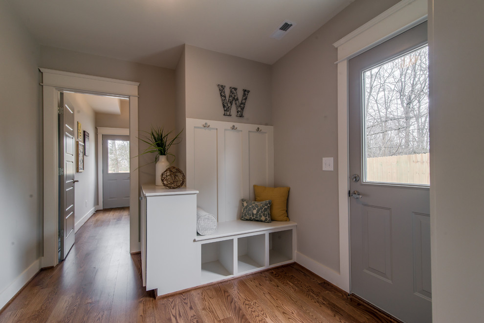 Mid-sized transitional mudroom in Nashville with grey walls and medium hardwood floors.