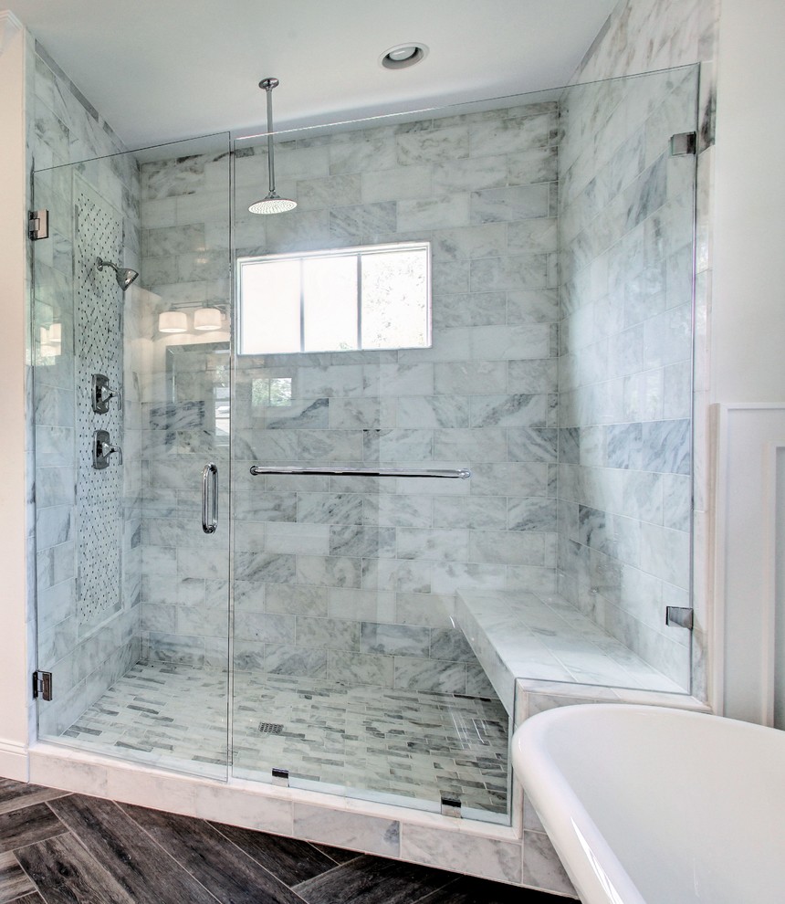 Photo of a mid-sized arts and crafts master bathroom in Atlanta with beaded inset cabinets, white cabinets, a freestanding tub, an alcove shower, marble, white walls, dark hardwood floors, an undermount sink, brown floor, a hinged shower door and marble benchtops.
