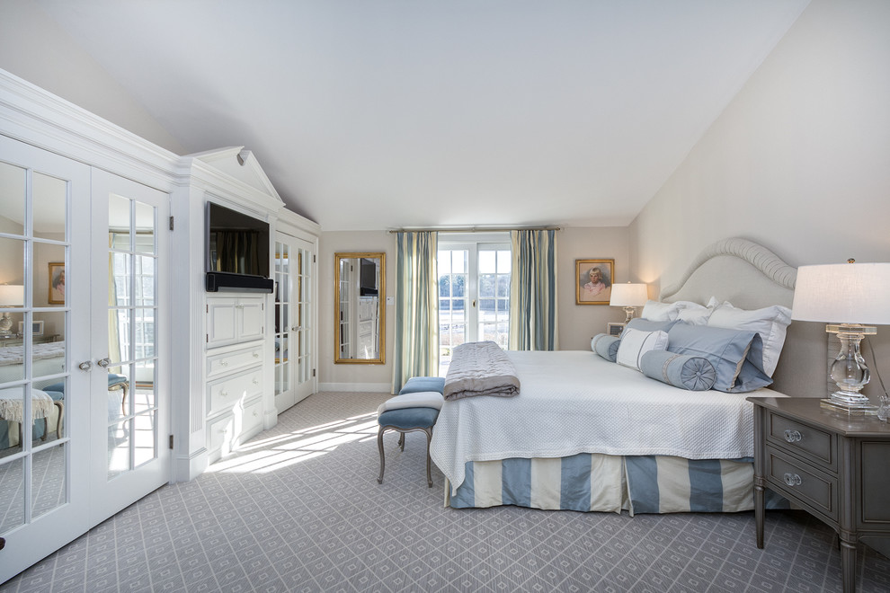 Design ideas for a traditional master bedroom in Boston with beige walls, carpet and grey floor.