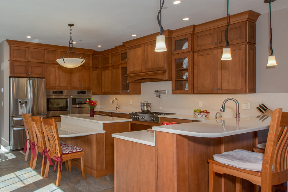 Example of a huge transitional u-shaped open concept kitchen design in Boston with an undermount sink, shaker cabinets, medium tone wood cabinets, quartz countertops, stone slab backsplash, stainless steel appliances and an island