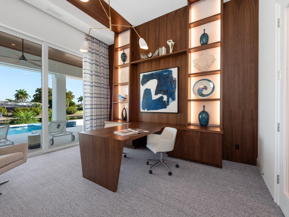 Photo of a contemporary home office in Miami with carpet, a built-in desk and recessed.