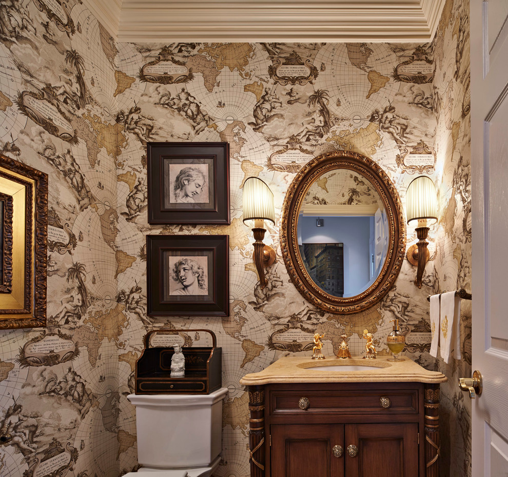 Design ideas for a mid-sized traditional powder room in Bridgeport with beaded inset cabinets, dark wood cabinets, multi-coloured walls, an undermount sink and limestone benchtops.