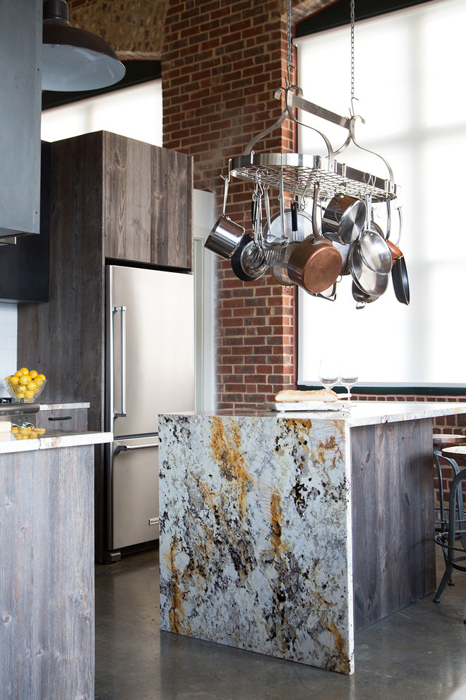 This is an example of an industrial kitchen in Atlanta with with island.
