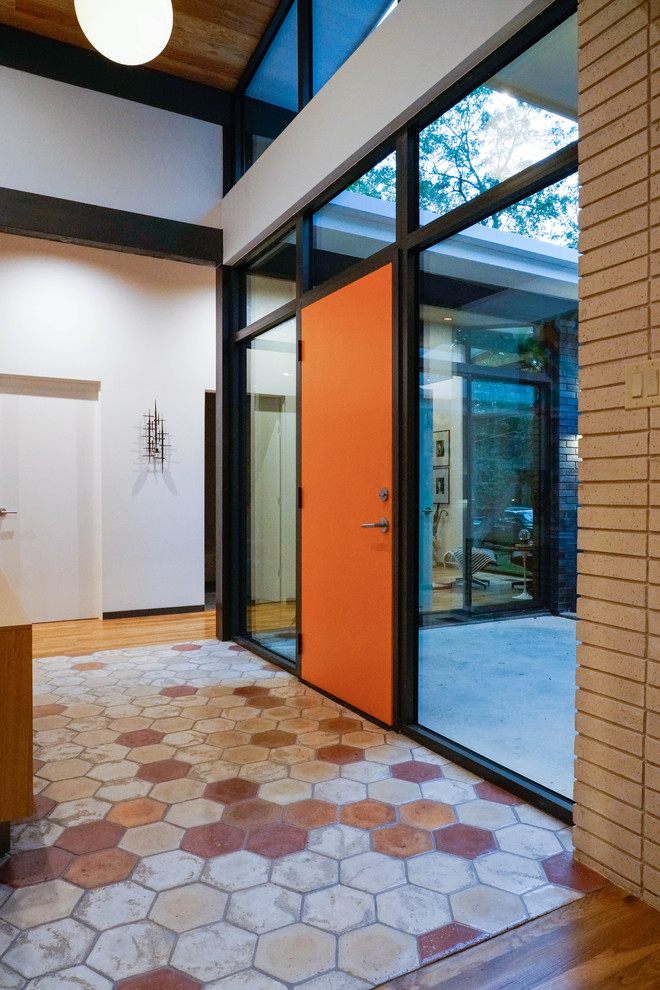 Design ideas for a small midcentury foyer in Dallas with terra-cotta floors, a single front door and an orange front door.