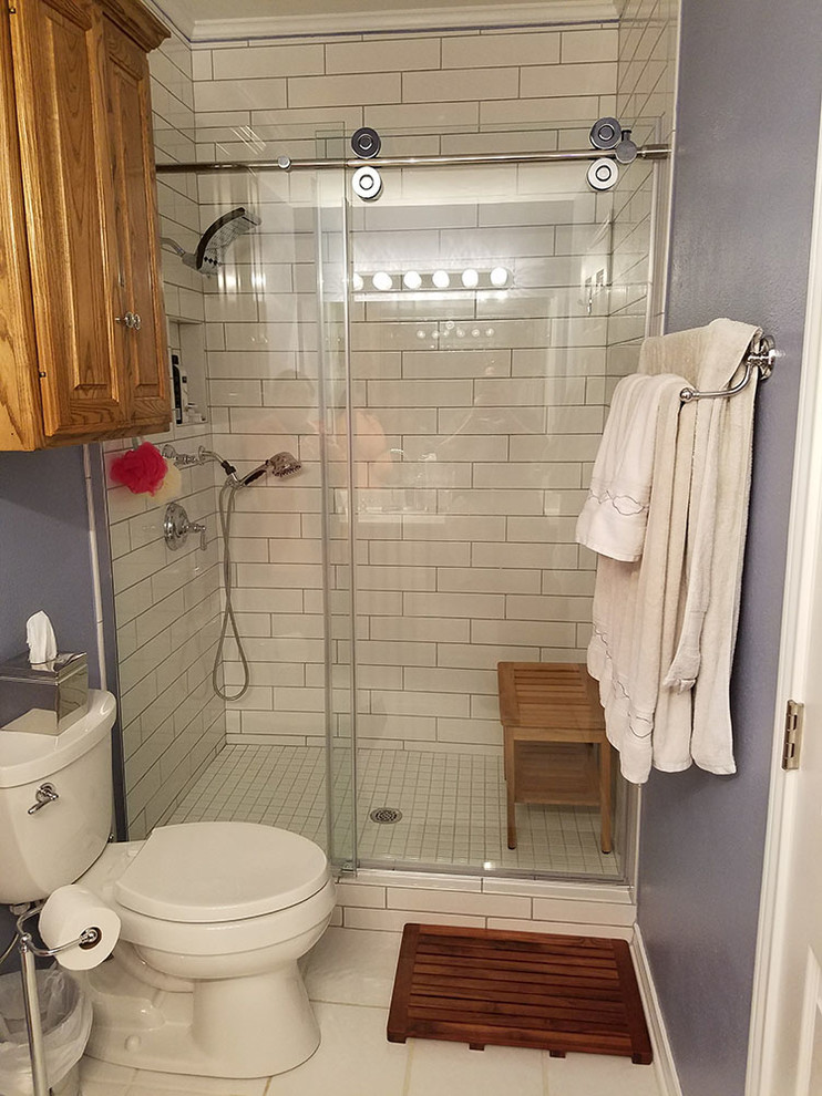 Design ideas for a small traditional 3/4 bathroom in Austin with raised-panel cabinets, light wood cabinets, an alcove shower, white tile, purple walls, white floor and a sliding shower screen.