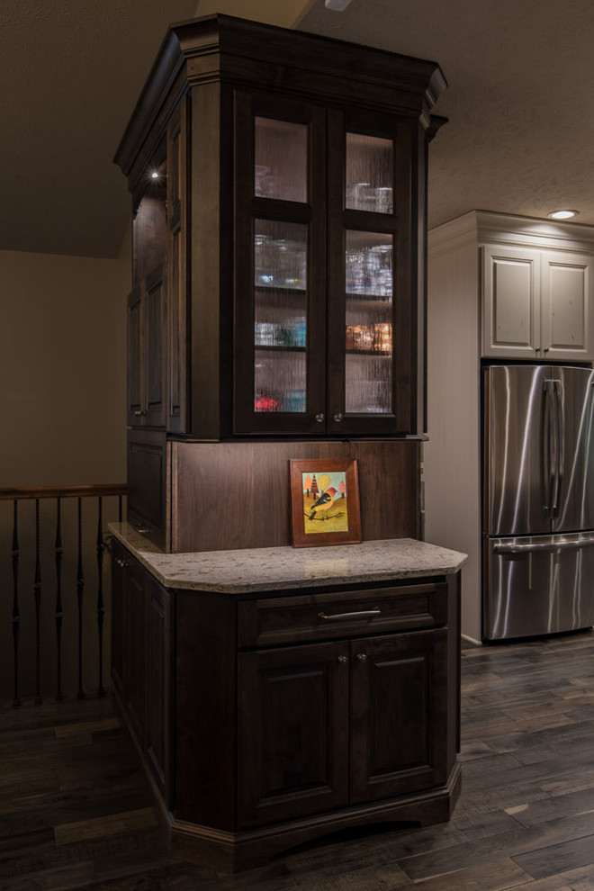 Example of a mid-sized transitional open concept kitchen design with raised-panel cabinets, white cabinets, quartz countertops, stainless steel appliances and an island