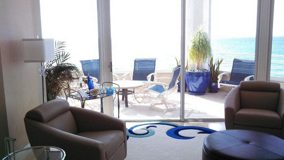 This is an example of a mid-sized beach style formal open concept living room in Miami with travertine floors.