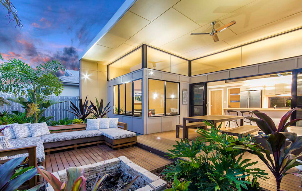 Small contemporary backyard deck in Brisbane with a fire feature and no cover.