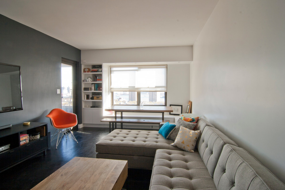 Example of a small 1950s open concept dark wood floor and black floor living room design in New York with white walls and a wall-mounted tv