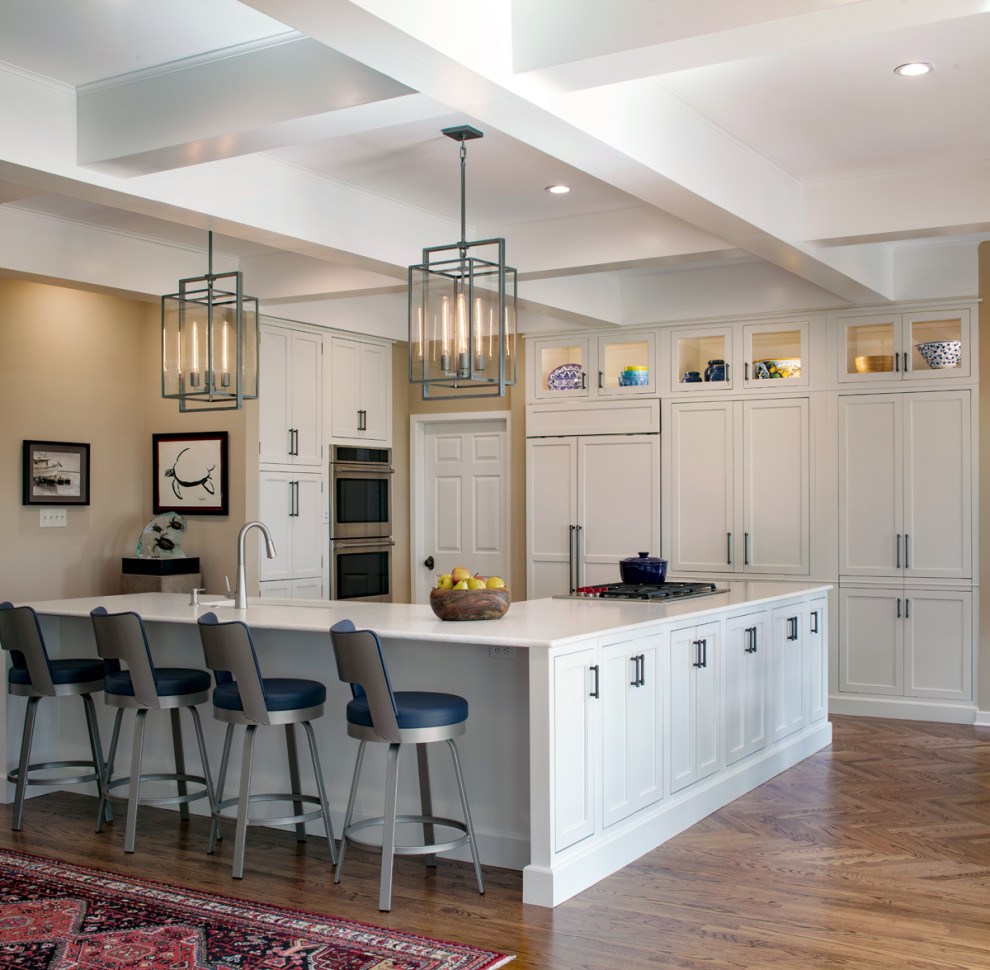 This is an example of a large traditional open plan kitchen in Atlanta with a single-bowl sink, shaker cabinets, white cabinets, engineered stone countertops, stainless steel appliances, medium hardwood flooring, an island, white worktops and a coffered ceiling.