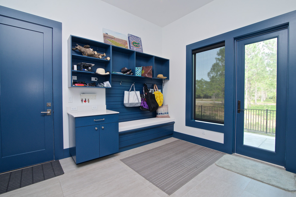 This is an example of a contemporary mudroom in Jacksonville with white walls, a single front door, a glass front door and grey floor.
