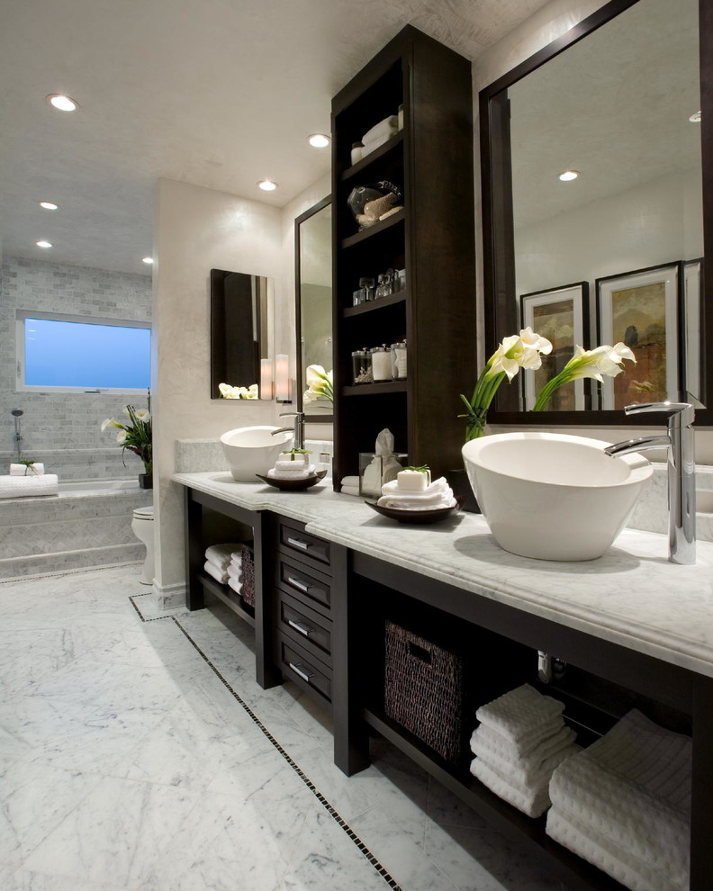 Photo of a transitional bathroom in Orange County with a vessel sink, marble benchtops, an undermount tub, white tile, white walls and marble floors.