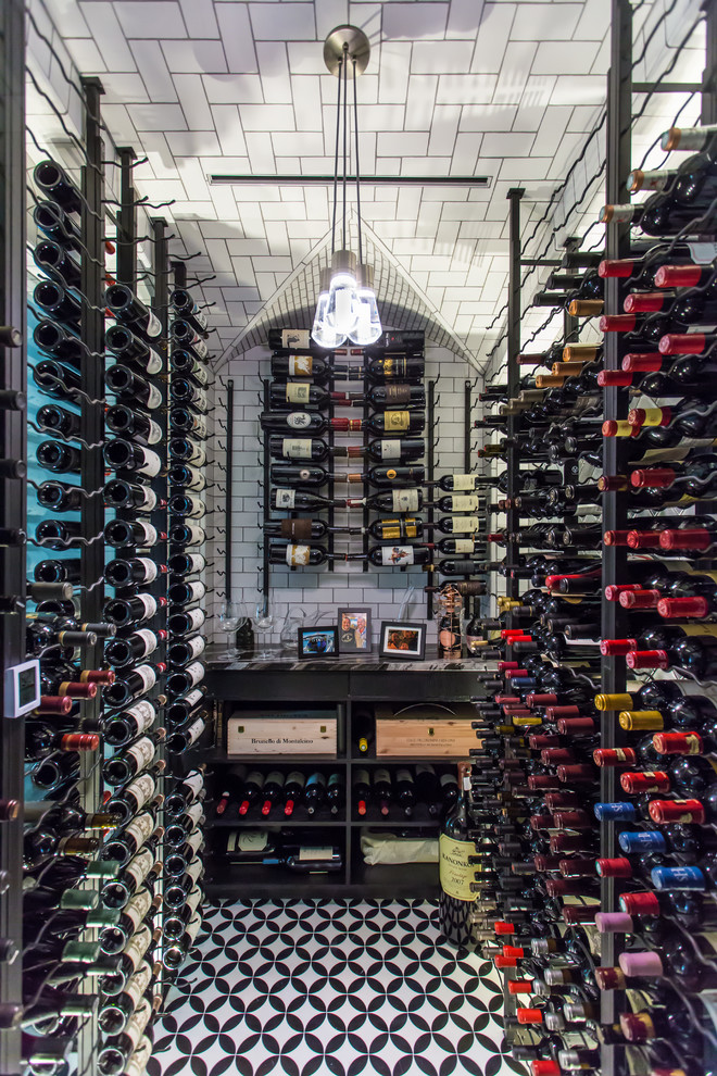 This is an example of a transitional wine cellar in Tampa with storage racks and multi-coloured floor.