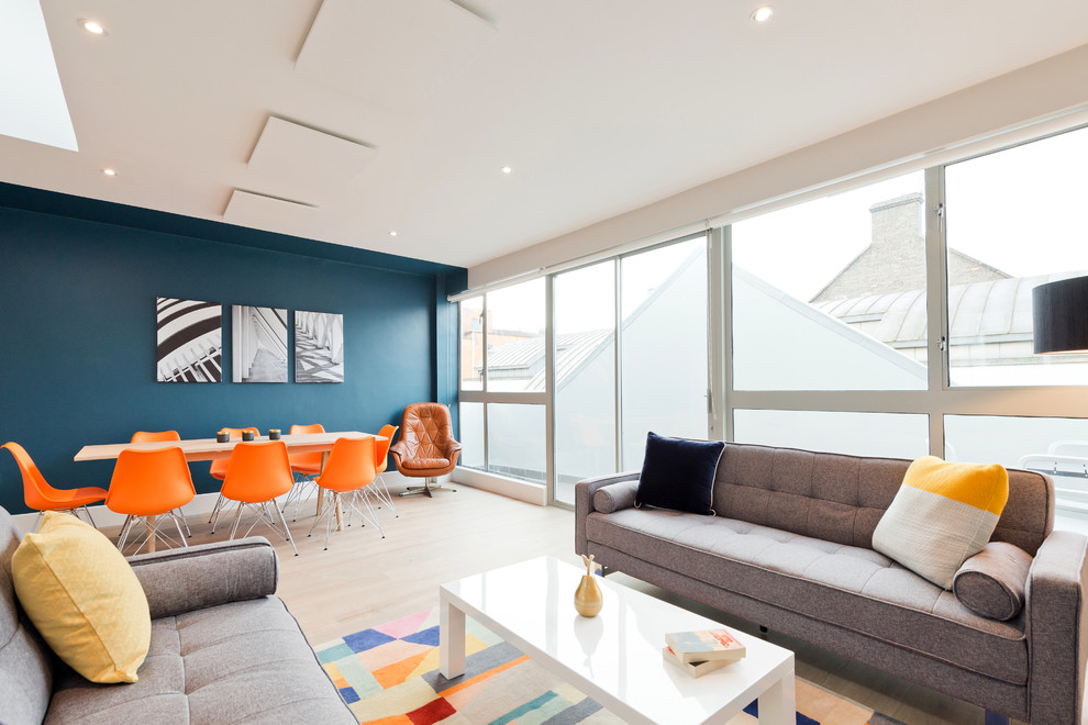 Inspiration for a mid-sized contemporary open concept living room in Dublin with multi-coloured walls, laminate floors, no fireplace and no tv.