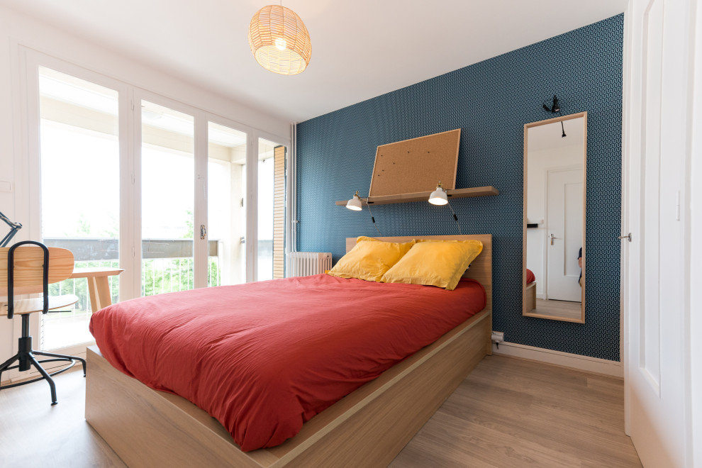 Photo of a small guest bedroom in Lyon with blue walls, light hardwood flooring, beige floors and wallpapered walls.