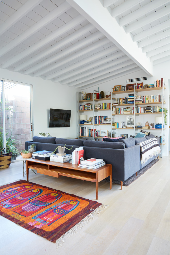 Midcentury loft-style family room in Los Angeles with a wall-mounted tv.
