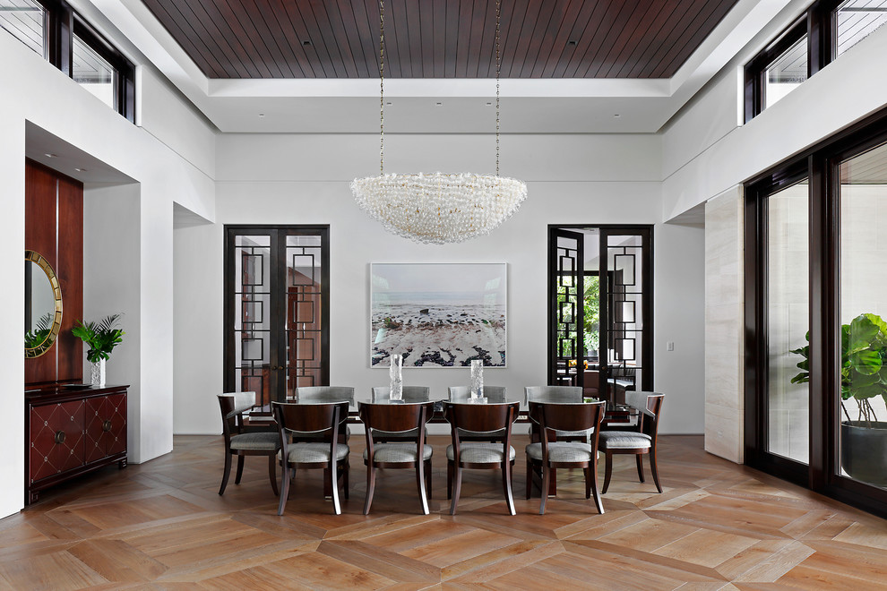 Contemporary dining room in Miami with white walls, light hardwood floors and no fireplace.