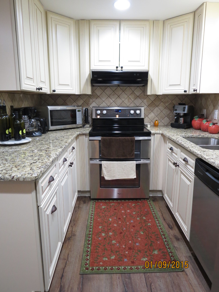 Mid-sized u-shaped eat-in kitchen photo in DC Metro with a double-bowl sink, raised-panel cabinets, white cabinets, granite countertops, beige backsplash, porcelain backsplash and stainless steel appliances