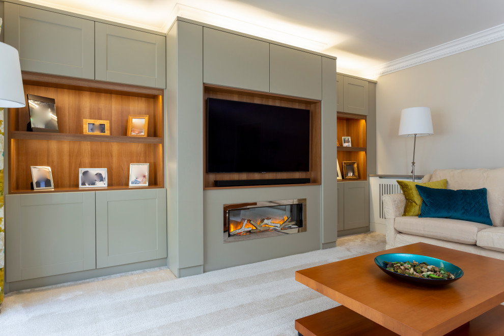 Design ideas for a large modern enclosed living room in Hertfordshire with a music area, grey walls, carpet, a hanging fireplace, a wood fireplace surround, a built-in media wall and beige floor.