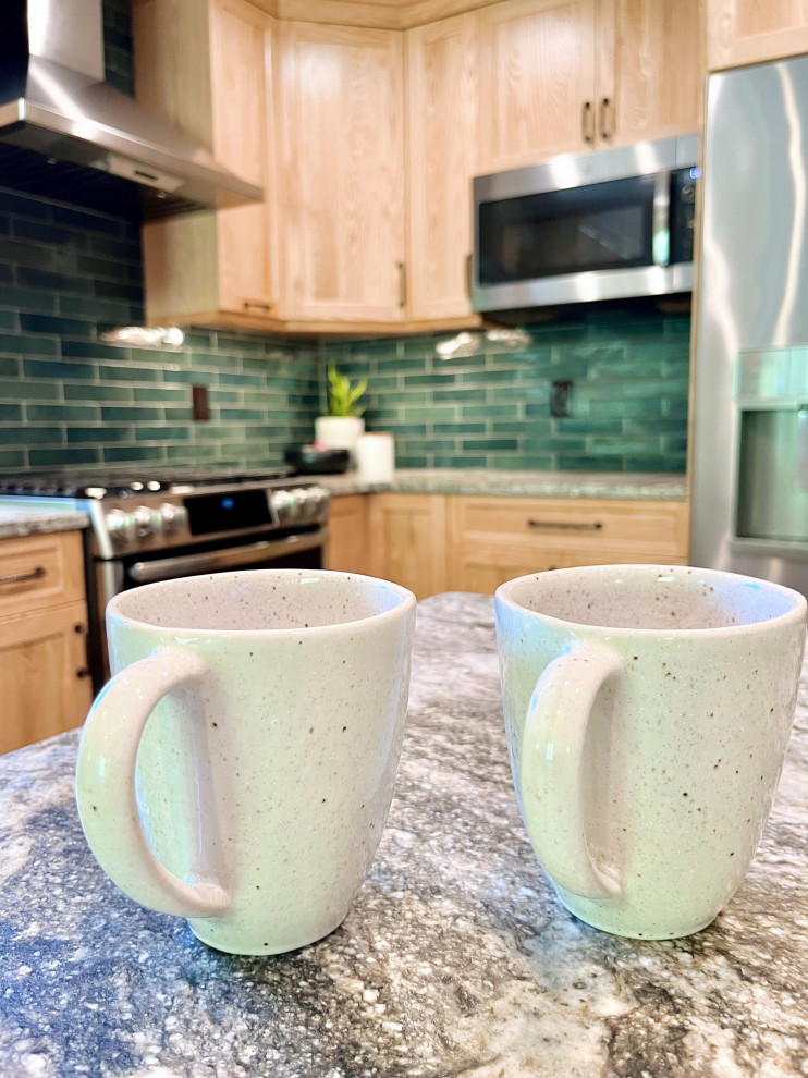Mid-sized transitional u-shaped vinyl floor and gray floor kitchen pantry photo with an undermount sink, shaker cabinets, light wood cabinets, granite countertops, green backsplash, porcelain backsplash, stainless steel appliances, a peninsula and gray countertops