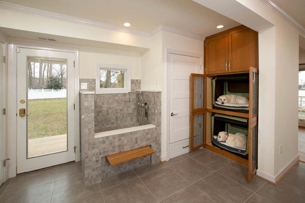 Photo of a mid-sized transitional l-shaped utility room in DC Metro with porcelain floors, shaker cabinets, medium wood cabinets and white walls.