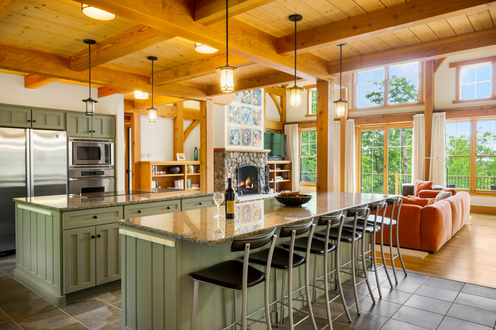 Inspiration for a large arts and crafts l-shaped open plan kitchen in Other with an undermount sink, shaker cabinets, green cabinets, granite benchtops, stainless steel appliances, slate floors, multiple islands, grey floor and exposed beam.