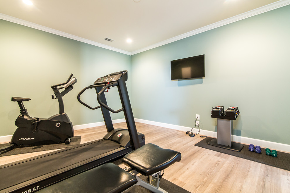 Inspiration for a mid-sized transitional multipurpose gym in DC Metro with blue walls, light hardwood floors and beige floor.