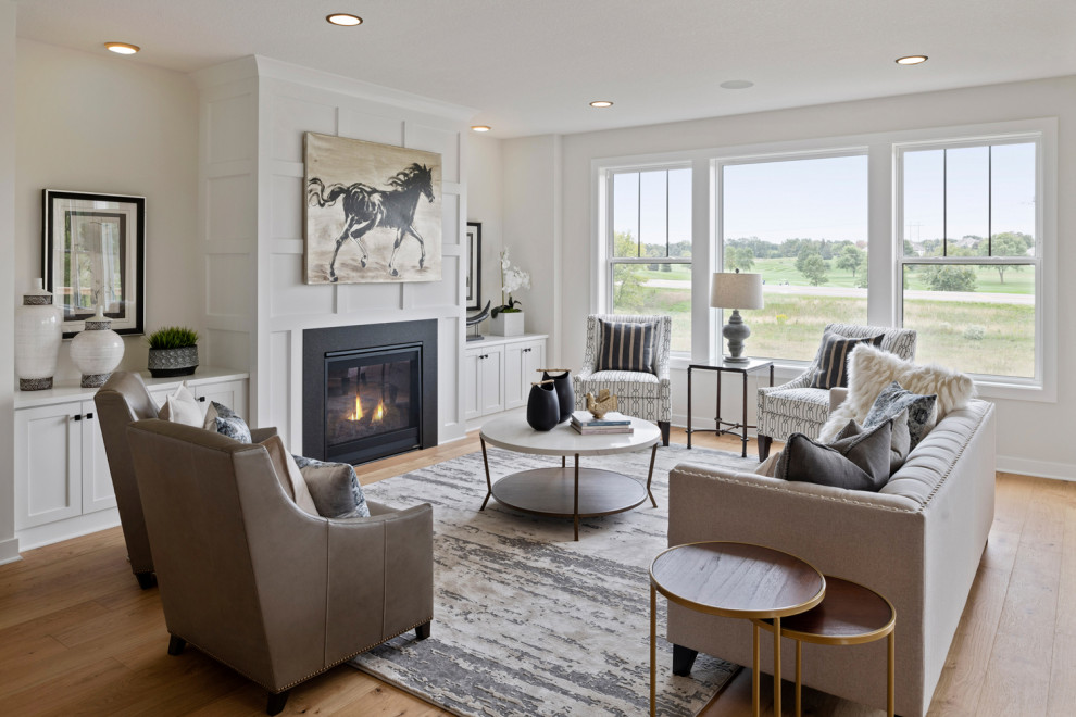 Large country open concept family room in Minneapolis with white walls, a standard fireplace, a stone fireplace surround, medium hardwood floors and brown floor.