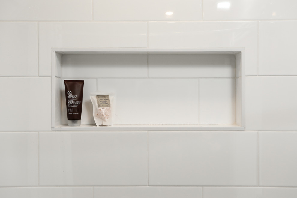 Alcove bathtub - mid-sized transitional white tile gray floor alcove bathtub idea with shaker cabinets, white cabinets, a one-piece toilet, gray walls, an undermount sink and gray countertops