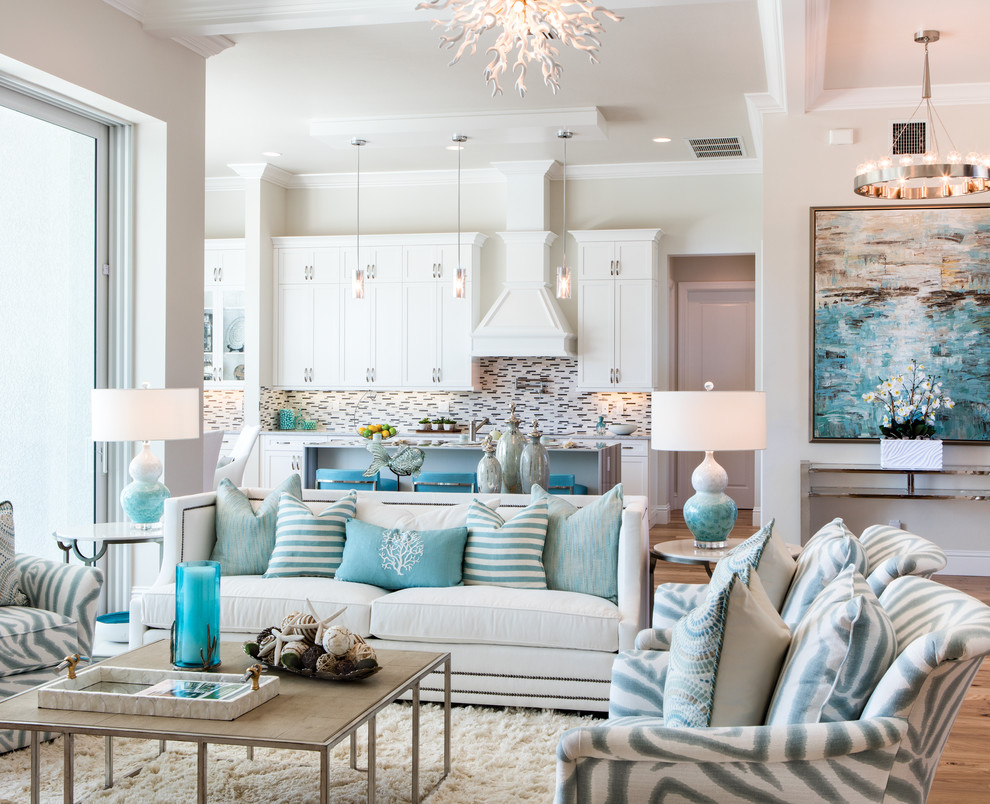 Example of a large beach style open concept medium tone wood floor living room design in Miami with beige walls