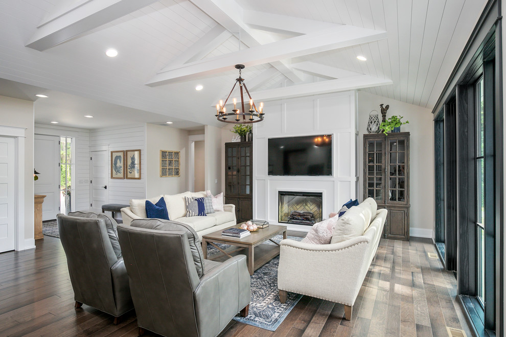 Design ideas for a country open concept family room in Grand Rapids with white walls, light hardwood floors and a built-in media wall.