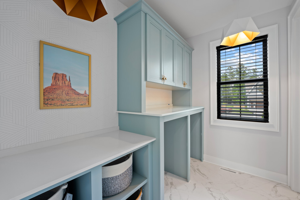 The Cardinal - Dedicated laundry room - mid-sized contemporary single-wall marble floor, white floor and wallpaper dedicated laundry room idea in Richmond with recessed-panel cabinets, turquoise cabinets, quartz countertops, white walls, an integrated washer/dryer and white countertops
