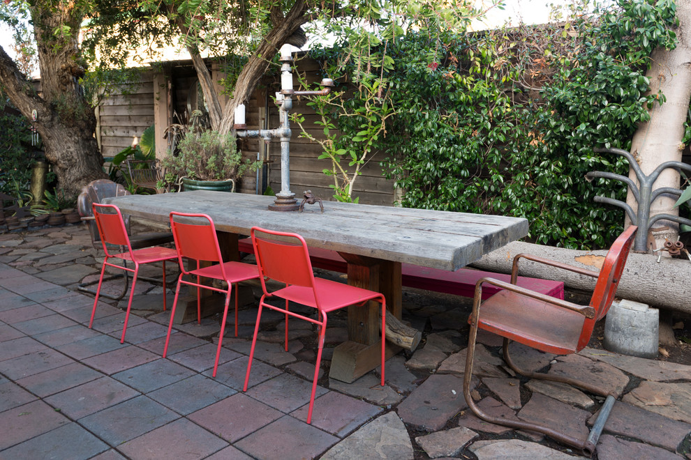 Design ideas for a mid-sized eclectic backyard patio in San Francisco with natural stone pavers and no cover.