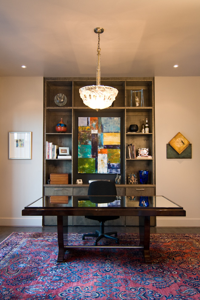 This is an example of an eclectic home office in Miami with beige walls, dark hardwood floors and a freestanding desk.
