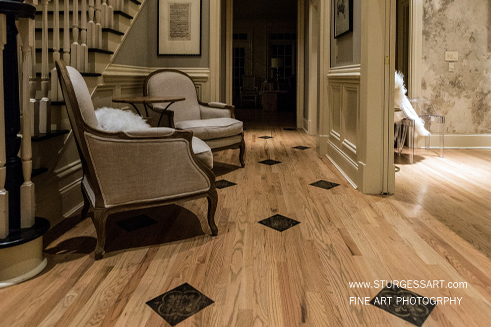 This is an example of a large traditional foyer in Atlanta with grey walls and light hardwood floors.