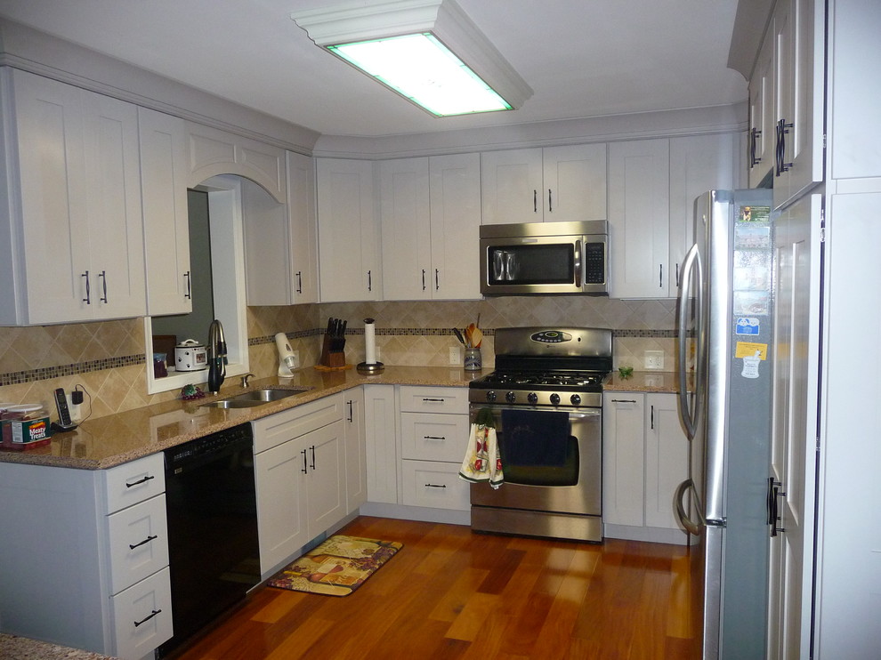 Transitional u-shaped eat-in kitchen photo in Philadelphia with an undermount sink, recessed-panel cabinets, white cabinets, quartz countertops, ceramic backsplash and stainless steel appliances