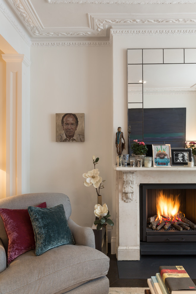Photo of a large classic formal enclosed living room in London with white walls, dark hardwood flooring, a standard fireplace, a stone fireplace surround, no tv and brown floors.