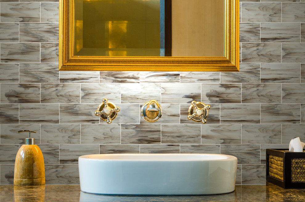 This is an example of a contemporary bathroom in Atlanta with a vessel sink, glass tile and multi-coloured walls.