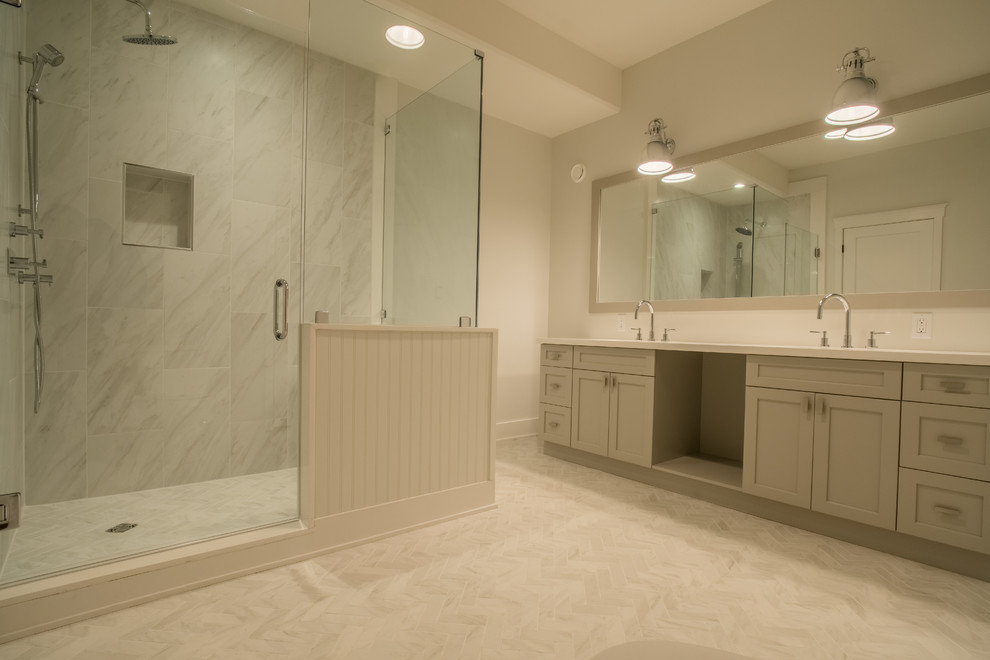 Design ideas for a large transitional master bathroom in Toronto with shaker cabinets, grey cabinets, a corner shower, gray tile, white tile, stone tile, white walls, ceramic floors, an undermount sink and solid surface benchtops.