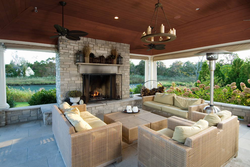 This is an example of a traditional patio in New York with a fire feature, concrete pavers and a roof extension.