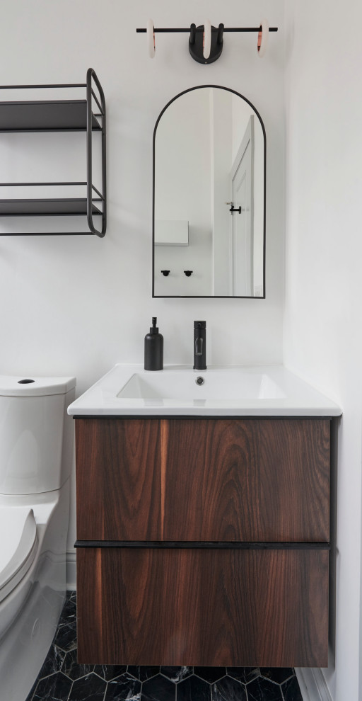 Small traditional ensuite bathroom in Chicago with flat-panel cabinets, brown cabinets, an alcove bath, a shower/bath combination, a two-piece toilet, white tiles, white walls, porcelain flooring, black floors, white worktops, a single sink and a floating vanity unit.