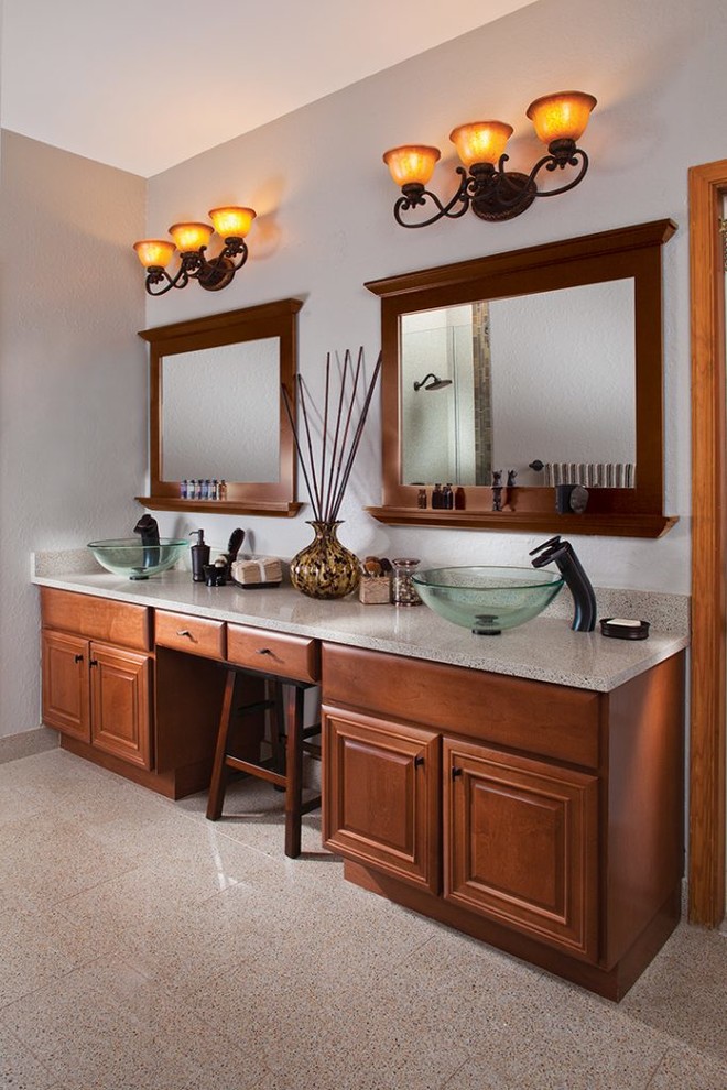 Photo of a large modern master bathroom in Jacksonville with raised-panel cabinets, dark wood cabinets, a corner tub, an alcove shower, a one-piece toilet, white tile, white walls, limestone floors, a vessel sink, granite benchtops, multi-coloured floor, a hinged shower door, multi-coloured benchtops, a double vanity, a built-in vanity and vaulted.