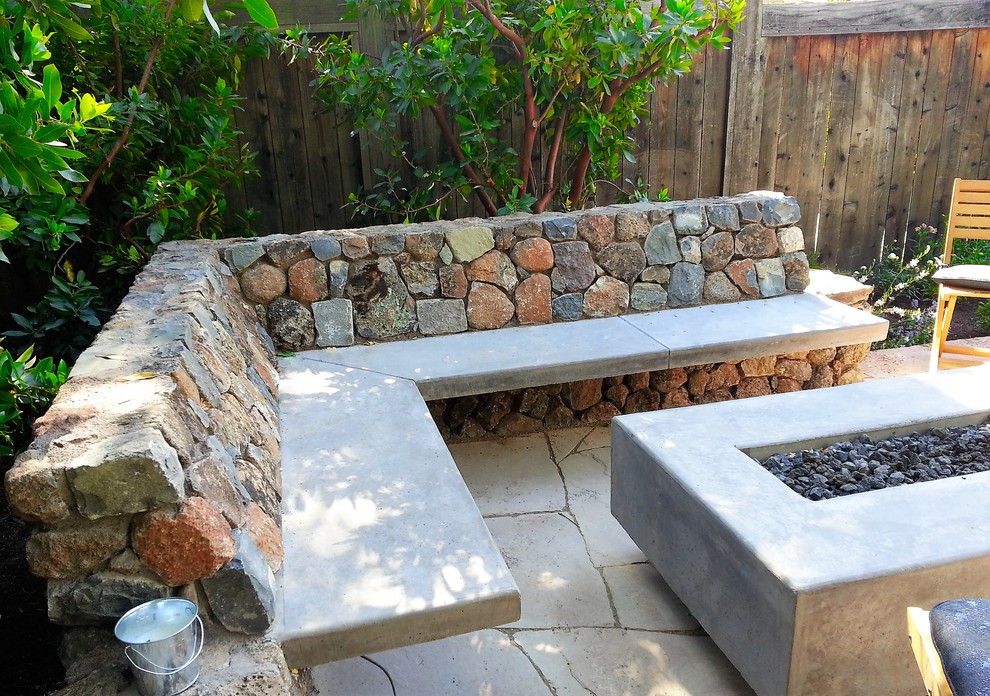 Photo of a small arts and crafts backyard patio in San Francisco with a fire feature, natural stone pavers and no cover.