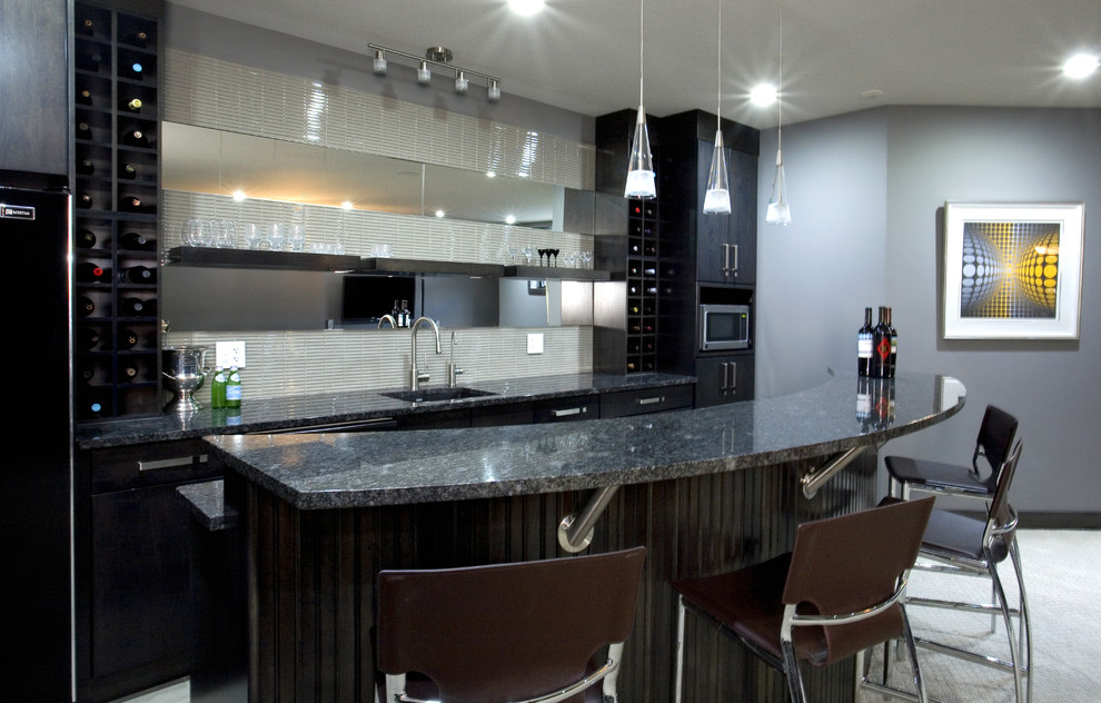 Photo of a large contemporary single-wall seated home bar in Other with an undermount sink, flat-panel cabinets, black cabinets, granite benchtops, grey splashback, grey floor and black benchtop.