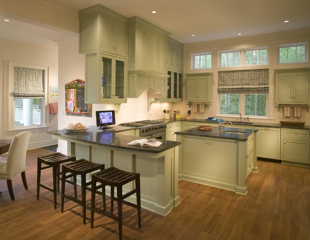 Design ideas for a traditional eat-in kitchen in Charleston with stainless steel appliances, recessed-panel cabinets and green cabinets.